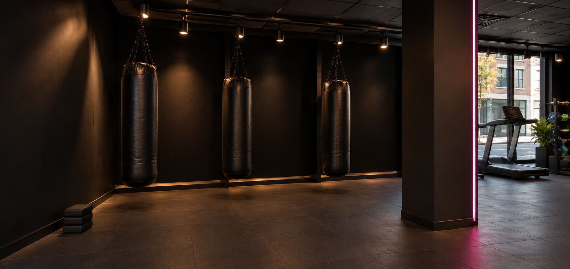 Woman in a boxing stance wearing pink-trimmed gloves, training at G-Force.