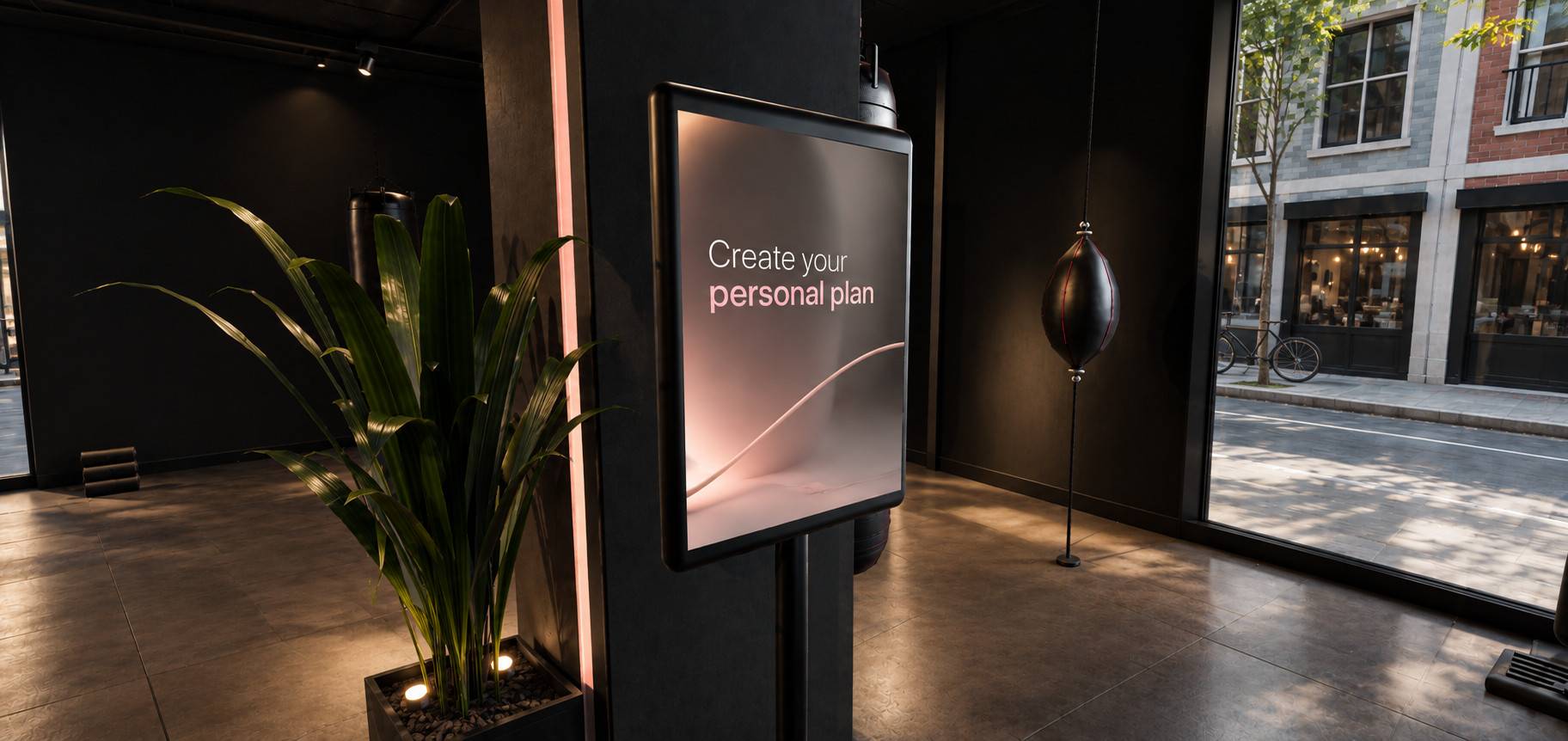 G-Force kiosk screen reading Create your personal plan, next to a plant and a speed bag.